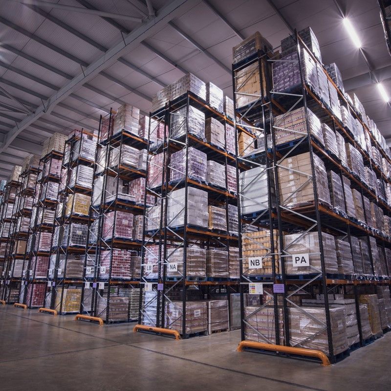 Bretts Transport warehouse with neatly stacked boxes, showcasing organised logistics operations.